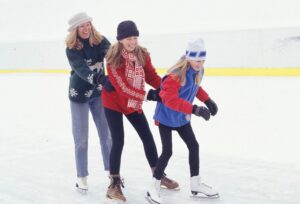 three young people ice skating