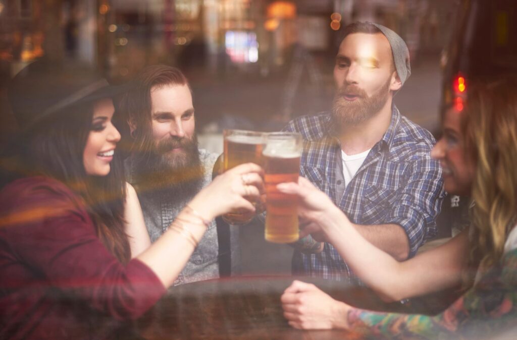 Young people enjoying a beer at a pub.