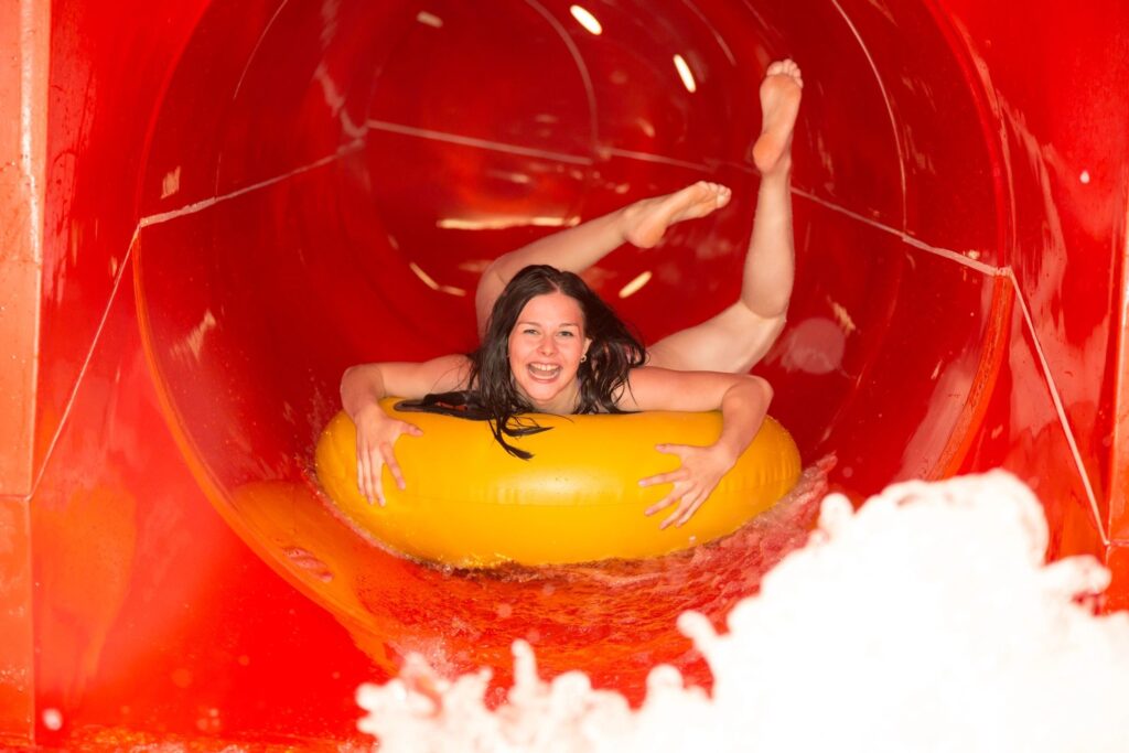 Girl slides thru a water tube
