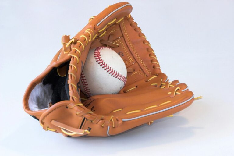 Baseball glove holding a baseball.
