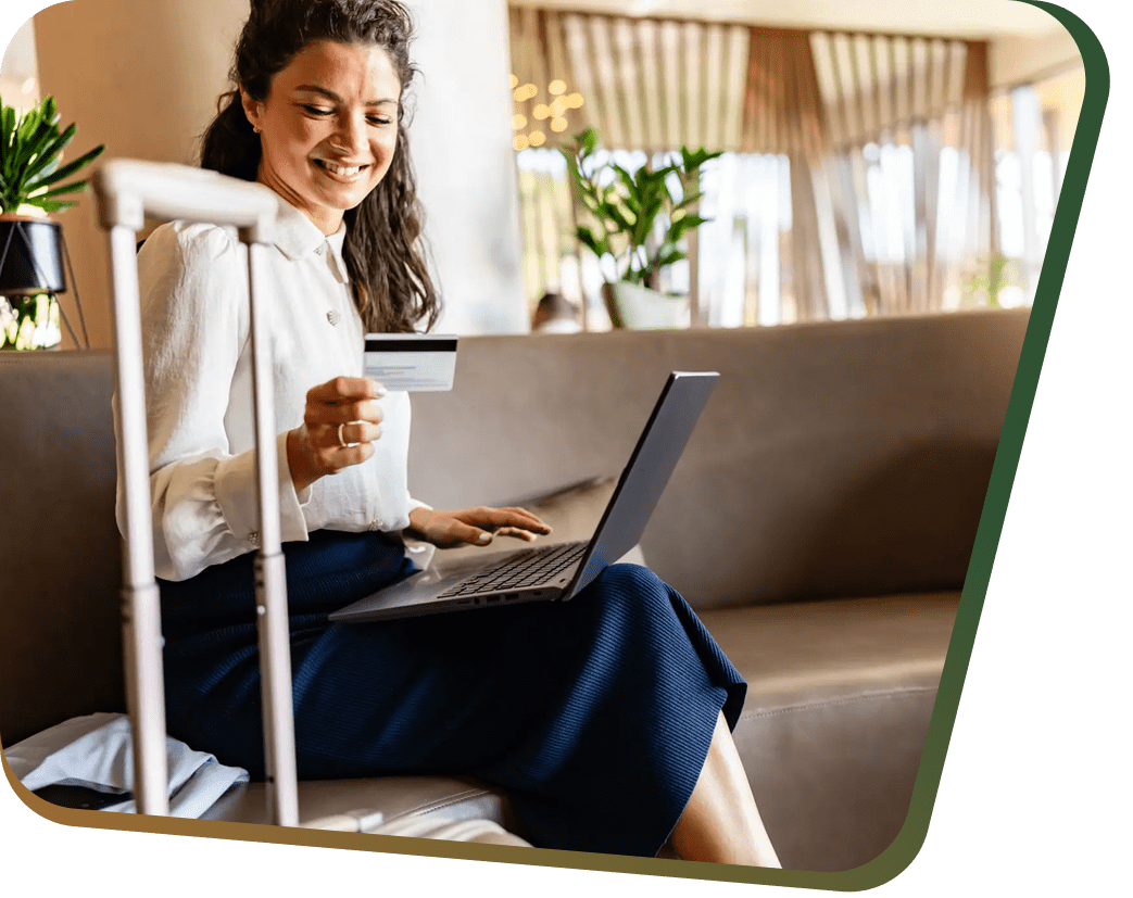 Woman booking travel in lounge with credit card