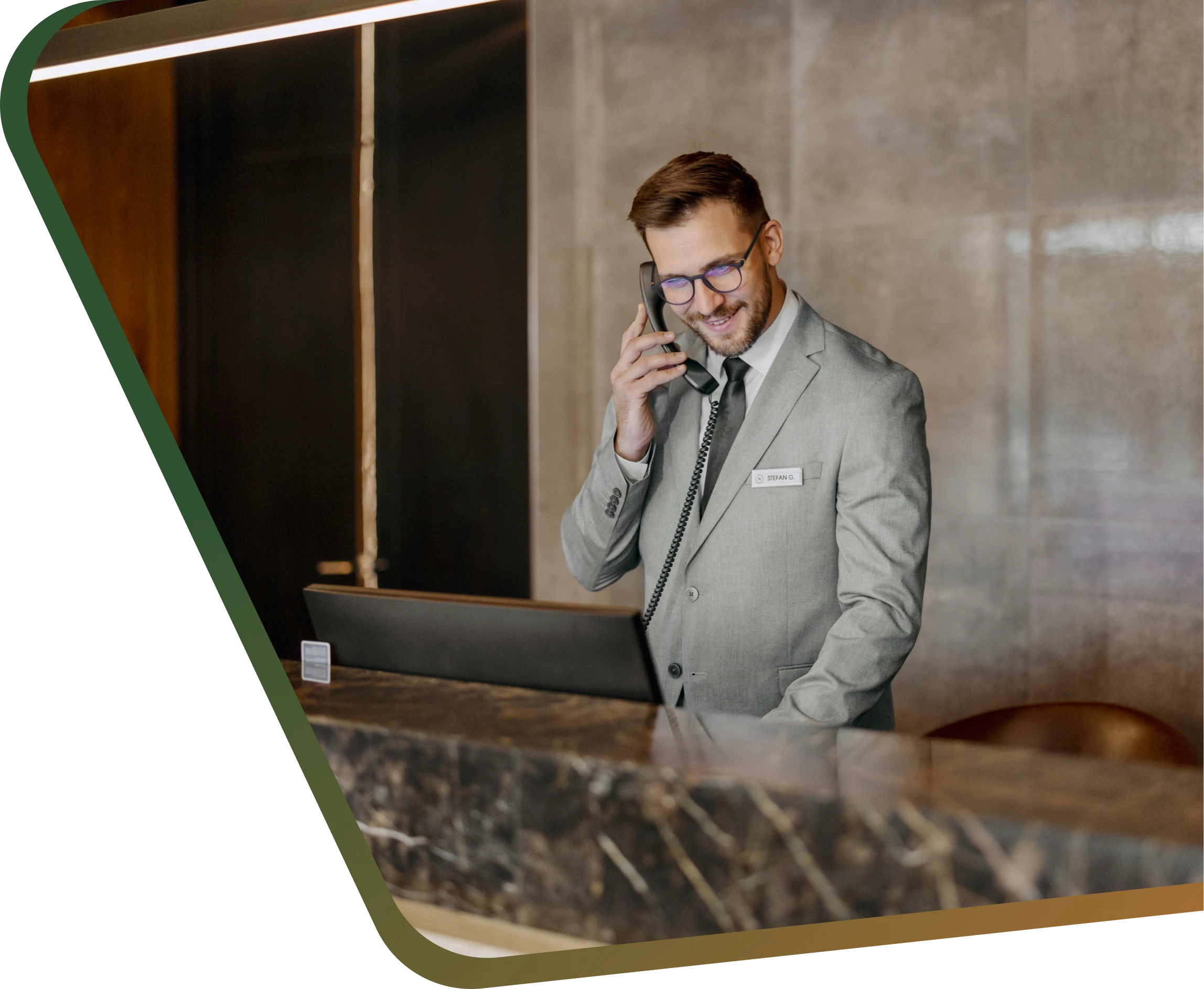 Receptionist in suit talking on phone.