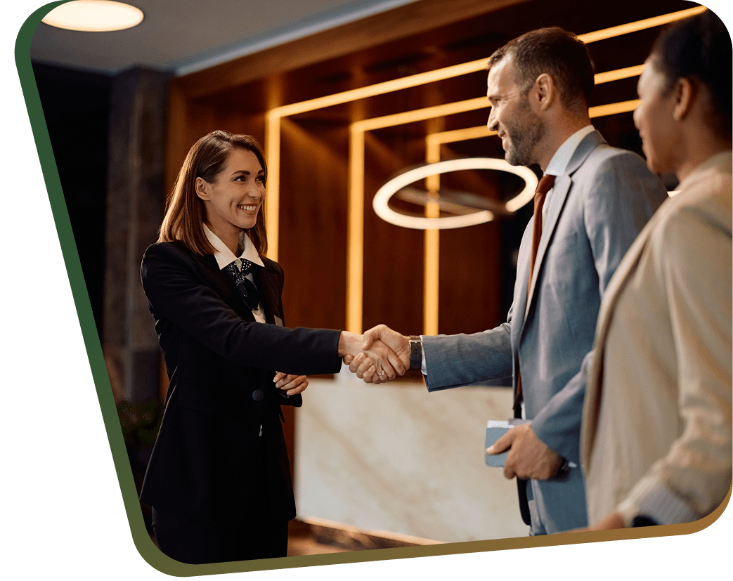 Business colleagues shaking hands in modern lobby